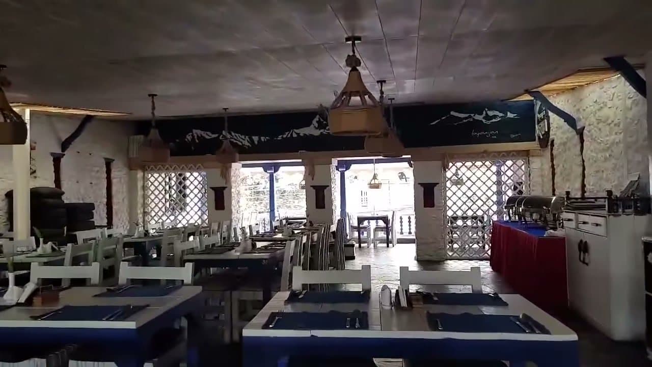 The upstairs dining room by day: lanterns, blue place mats and open windows.